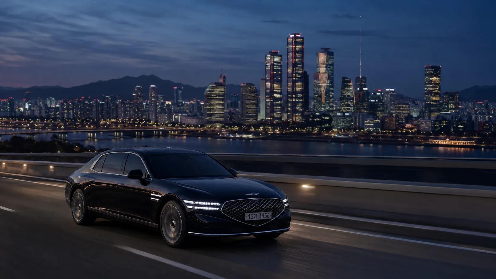 Black Genesis G90 sedan on a Seoul expressway at blue hour